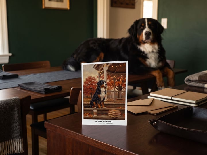 The "The Town Square" card on a sideboard with a Bernese Mountain Dog lying in the doorway behind