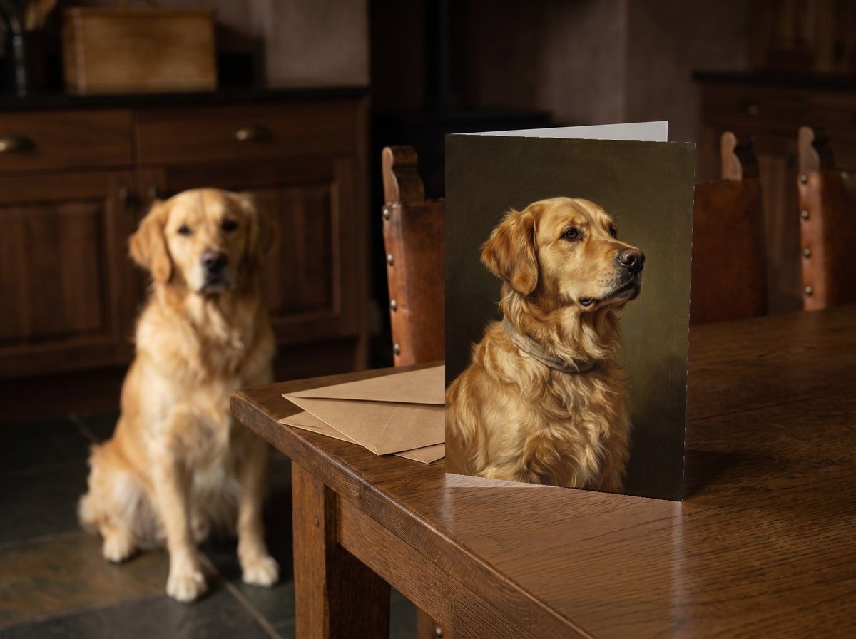 The "The Keepsake" card standing on a dark oak kitchen table with a Golden Retriever sitting behind it