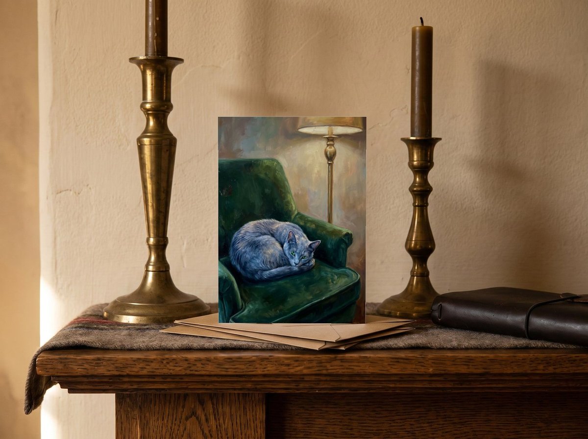 A card standing upright — on a mantel between brass candlesticks