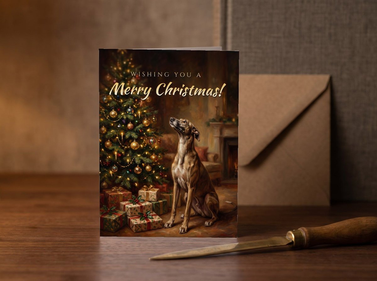 A card standing upright — on a walnut desk with one envelope leaning behind it