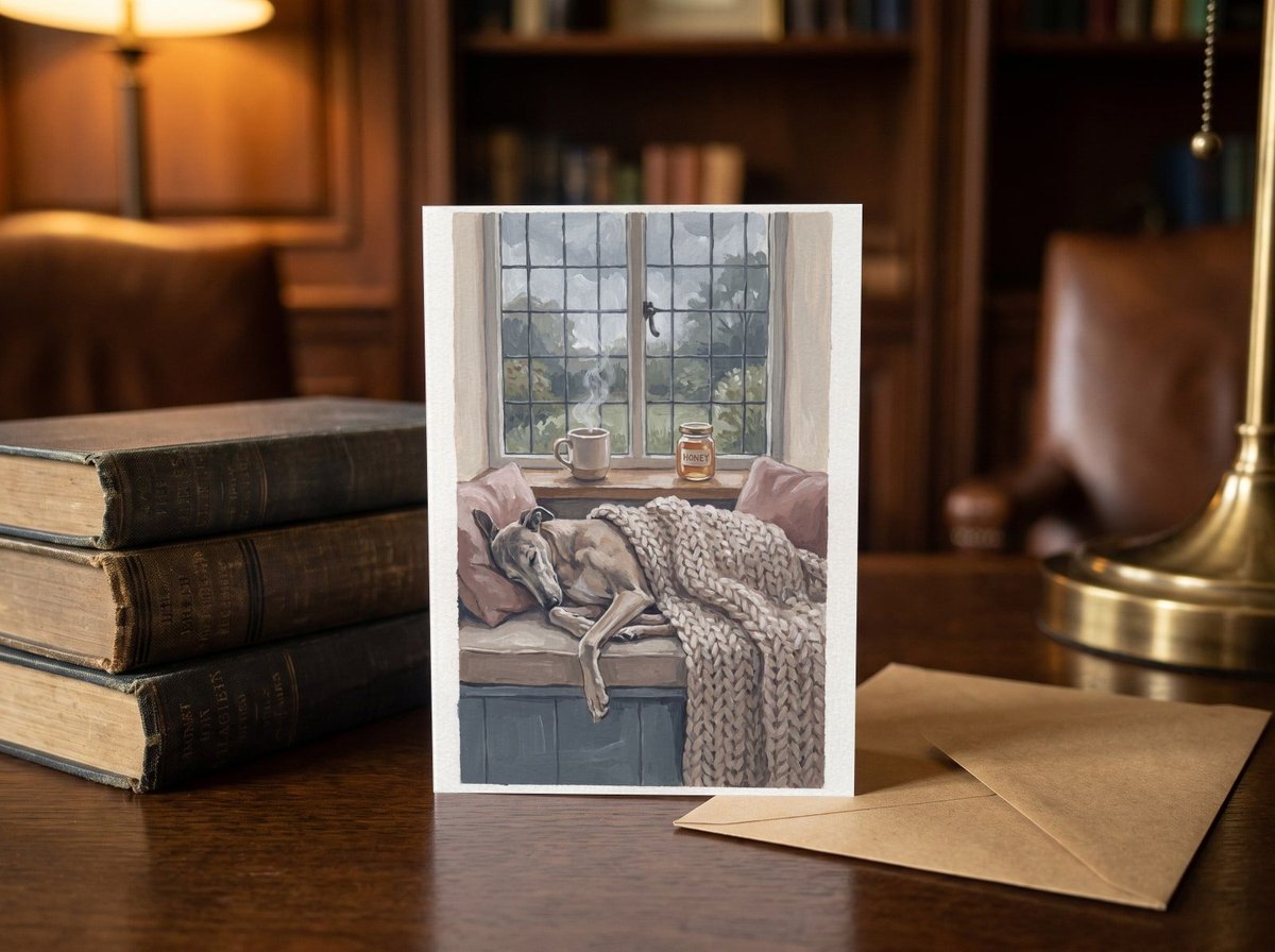 A card standing upright — on a library desk between old books and an envelope