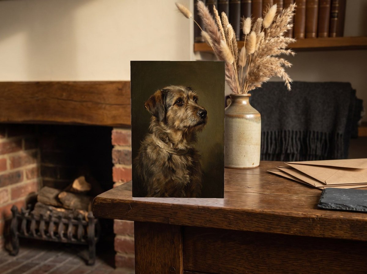 A card standing upright — on an oak mantel beside a vase of dried grasses