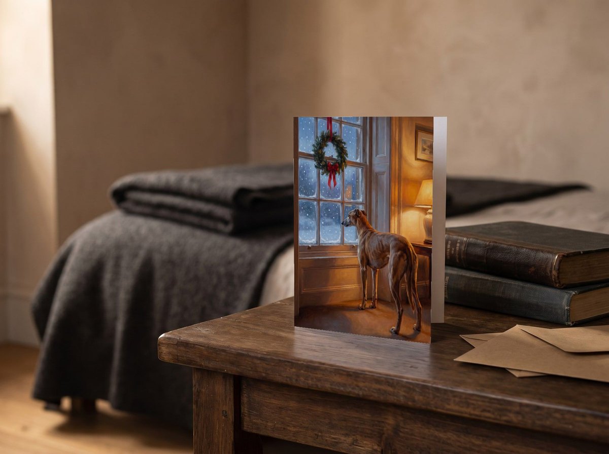 A card standing upright — on a bedside table beside two books