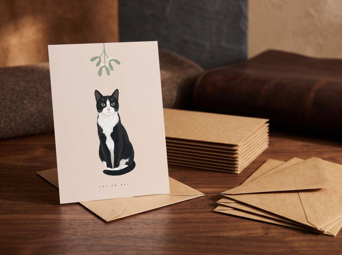 A card standing upright — in front of a stack of matching cards and fanned envelopes