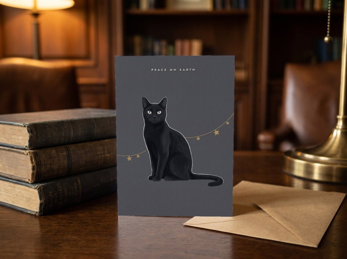 A card standing upright — on a library desk between old books and an envelope