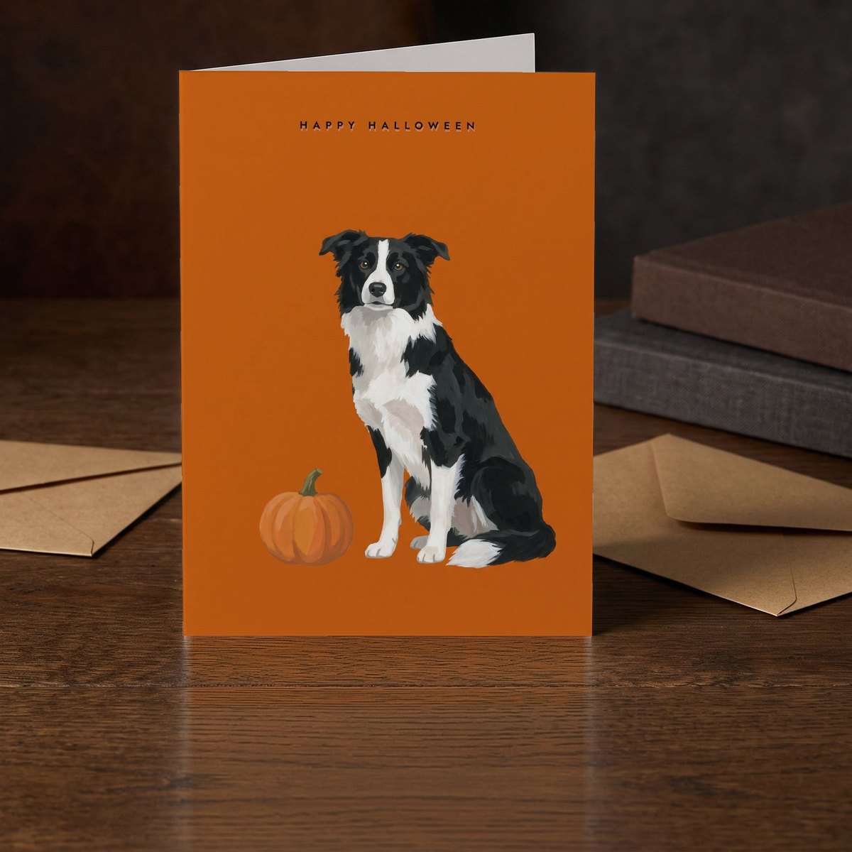 A folded card standing on a dark oak table beside two clothbound books